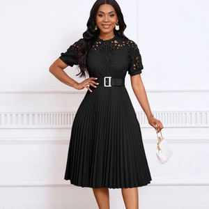 Detail of black lace bodice with pleated skirt and metallic buckle belt on dress