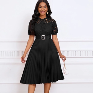 Close-up of black pleated dress featuring intricate lace bodice and belted waist details