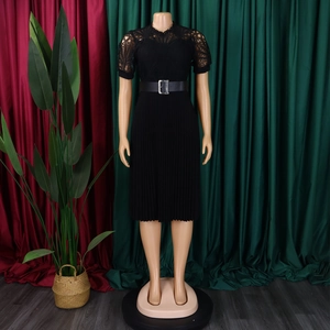 Detail of lace bodice and pleated skirt of a black midi dress with a square buckle belt