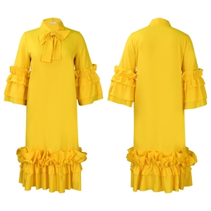 Detailed view of yellow maxi dress with tiered ruffles and elegant bow tie neckline