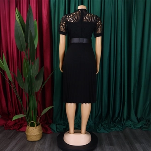 Detail of fan-shaped lace back design and pleated skirt on a black dress