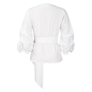 Detail of white puff sleeves and wrap-around waist tie on a stylish summer blouse