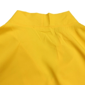 Detail shot of the V-neckline on a yellow summer dress with clean stitching and woven fabric