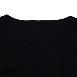 Close-up of invisible zipper closure on the back of a black pleated v-neck dress