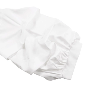 Detail of white puff sleeve cuff with elastic ruching and textured cotton fabric