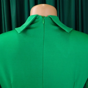 Détail d'une robe de soirée verte avec col chemise et fermeture éclair invisible au dos