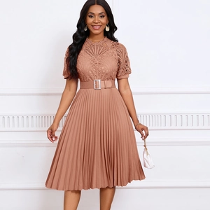 Close-up of lace patchwork bodice and pleated skirt detail on a dusty rose dress