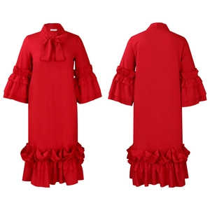 Detail of red dress with layered ruffle sleeves and a large decorative bow at the neckline