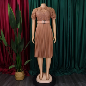 Detail of terracotta short sleeve dress with lace patchwork and pleated skirt design