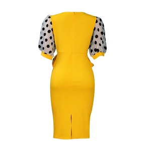 Detail of yellow bodycon dress showing back invisible zipper and mesh polka dot puff sleeves