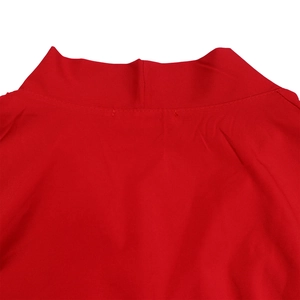 Detailed view of red dress mock neck collar with clean stitching and premium fabric texture