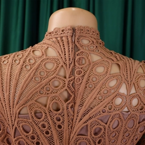 Detailed close-up of rose pink lace dress featuring back invisible zipper and high neck