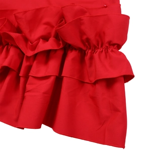 Detailed close-up of layered ruffle sleeves and pleated texture on a vibrant red dress