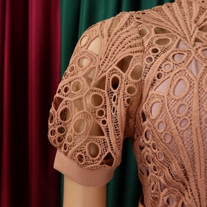 Detail of dusty pink lace short sleeves featuring intricate geometric hollowed-out patterns