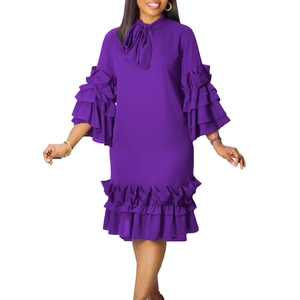 Detail of deep purple dress featuring tiered ruffle sleeves and a decorative neck bow