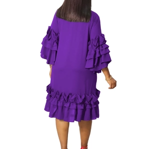 Back view of a purple midi dress featuring layered ruffle flare sleeves and flowing hemline
