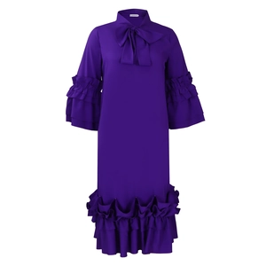 Detail of dark purple midi dress with large bow neckline and tiered ruffle flare sleeves