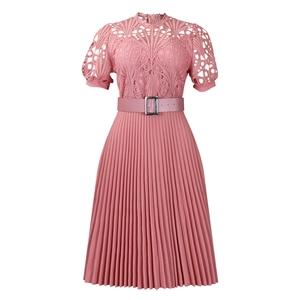 Detail of pink dress featuring intricate lace hollow-out work and elegant pleated skirt