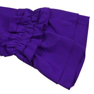 Detail of layered ruffle sleeve in dark purple fabric with elegant smooth texture