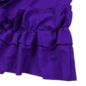 Detail view of the multi-layered purple ruffles and lightweight fabric of the dress