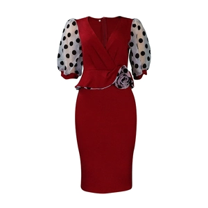 Detail view of burgundy V-neck pencil dress featuring 3D floral waist and polka dot puff sleeves