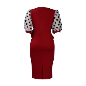 Rear view of wine red pencil dress with sheer polka dot puff sleeves and back slit