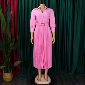 Detail view of pink pleated midi dress with lapel V-neckline and matching buckle belt