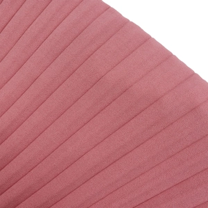 Detail of pink velvet fabric featuring vertical pleated texture and elegant matte finish