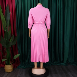 Detail view of the pink pleated midi dress back featuring a waist belt and lapel collar