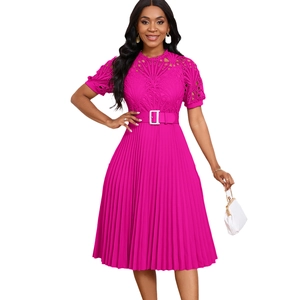 Detail of fuchsia pleated dress showing intricate lace patchwork and silver buckle belt