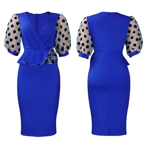 Close-up of royal blue pencil dress with mesh polka dot puff sleeves and waist rose detail