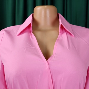Close-up of the elegant pink lapel collar and fine stitching on the long sleeve dress
