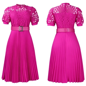 Detail of rose red lace stitching and pleated fabric on an African style dress