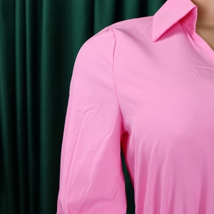 Detail of pink long-sleeve shirt collar and pleated shoulder seams on female mannequin