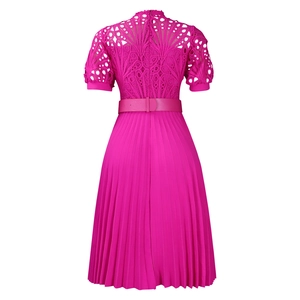 Detailed fuchsia dress featuring intricate lace hollow-out design and pleated skirt texture