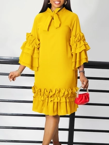 Elegant yellow summer dress with ruffle sleeves, tie neck, and pleated hemline detail