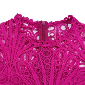 Detail of rose red lace dress featuring intricate hollow-out patterns and invisible zipper