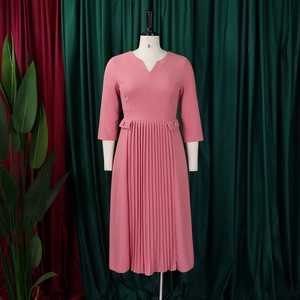 Detail of V-neck dusty pink dress showing pleated 3/4 sleeves and belted waist detail