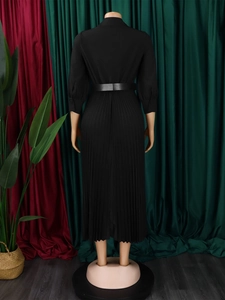 Back view of elegant black long-sleeve pleated dress with lapel and waist belt