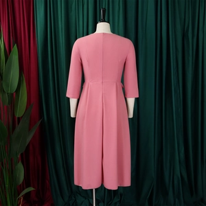 Rear view of pink midi dress with three-quarter sleeves and pleated waist on a mannequin