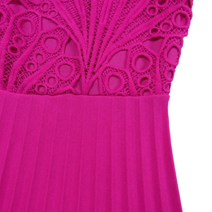 Detail of fuchsia dress featuring intricate hollow lace and vertical pleated fabric texture