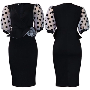 Close-up of contrast polka dot puff sleeves and floral waist detail on slim V-neck dress