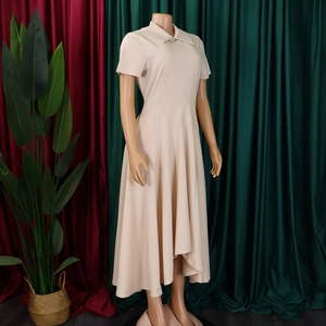 Détail de la robe abricot à manches courtes avec taille haute et jupe plissée élégante
