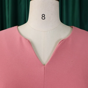 Detail of pink chiffon blouse showing the smooth V-neckline and textured fabric on mannequin