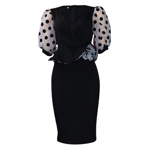 Detail of V-neck dress with polka dot organza puff sleeves and gray rose applique