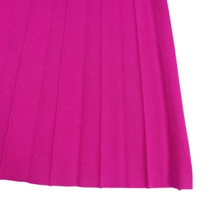 Detailed macro view of magenta pleated fabric texture and vertical fold design