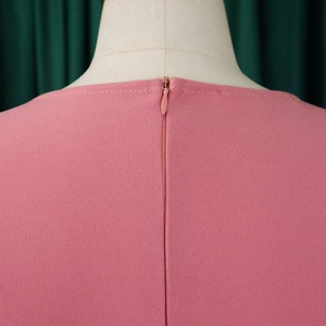Detail of pink plus size dress featuring an invisible zipper back and textured fabric