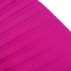 Detailed macro view of magenta pleated fabric texture and delicate vertical fold patterns