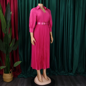 Detail of rose red pleated dress featuring lapel collar and metal buckle belt