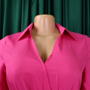 Detailed view of the elegant rose pink V-neck collar and long sleeve shirt fabric texture